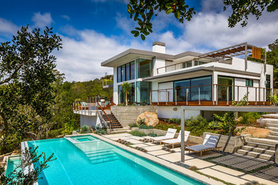 This is an example of a contemporary backyard rectangular infinity pool in Santa Barbara.