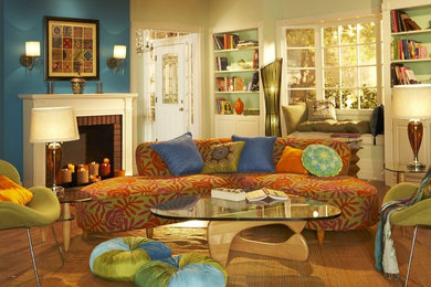 Example of a large trendy living room design in Los Angeles with blue walls, a brick fireplace and a standard fireplace