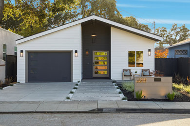 Mid-sized trendy one-story concrete fiberboard exterior home photo in San Francisco with a shingle roof