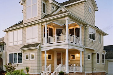 Inspiration for a large timeless beige two-story wood exterior home remodel in Philadelphia