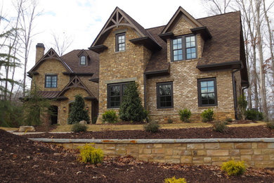 This is an example of a large transitional two-storey brown exterior in Atlanta with mixed siding and a gable roof.