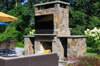 This is an example of a large traditional full sun landscaping in New York with a fireplace.