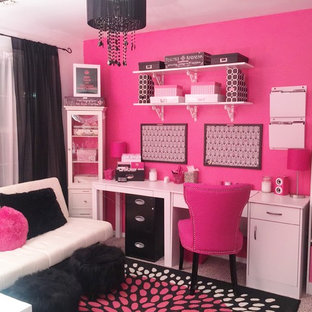 This is an example of a small modern home office and library in New York with pink walls.