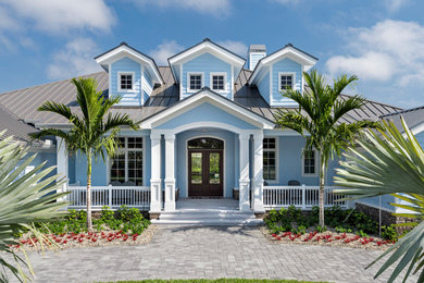 Large transitional blue one-story stucco gable roof idea in Miami
