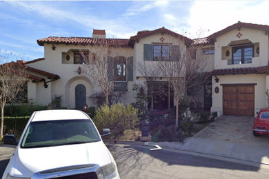 Example of a large tuscan white two-story stucco exterior home design in Los Angeles with a tile roof and a red roof
