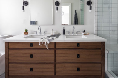 Inspiration for a country master bathroom in Toronto with furniture-like cabinets, an alcove shower, a two-piece toilet, white tile, ceramic tile, white walls, porcelain floors, an undermount sink, engineered quartz benchtops, grey floor and a hinged shower door.