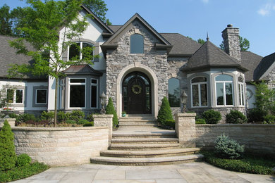 Example of a large transitional two-story mixed siding exterior home design in Cleveland