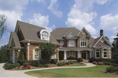 Large victorian brown two-story brick exterior home idea in Columbus with a shingle roof