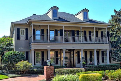 Large elegant beige two-story vinyl exterior home photo in Orlando with a hip roof