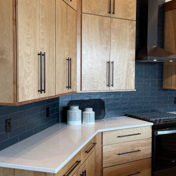 Angled Kitchen Design with Slab Style Cabinets in Pecan Stain