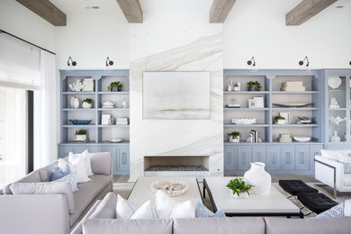 Example of a tuscan light wood floor living room design in San Diego with white walls, a ribbon fireplace and a stone fireplace