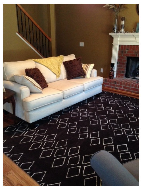 Modern Rug and Traditional Fireplace.
