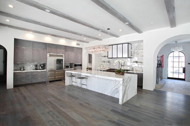 Inspiration for a large timeless l-shaped kitchen remodel in Santa Barbara with flat-panel cabinets, gray cabinets, stainless steel appliances and an island