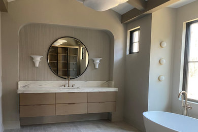 Example of a huge minimalist master beige tile and ceramic tile cement tile floor, beige floor, single-sink and exposed beam freestanding bathtub design in New York with flat-panel cabinets, an undermount sink and a floating vanity
