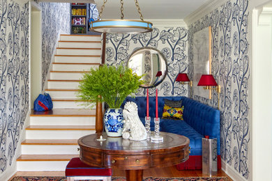 Inspiration for a large eclectic medium tone wood floor, brown floor and wallpaper foyer remodel in Omaha with multicolored walls