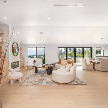 Open Living and Dining Under a Vaulted White Ceiling