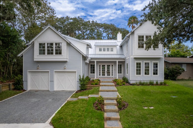 Inspiration for a coastal gray two-story exterior home remodel in Jacksonville with a metal roof and a gray roof