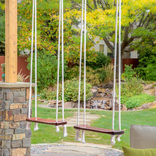 Large transitional backyard patio in Boise with an outdoor kitchen, stamped concrete and a roof extension.