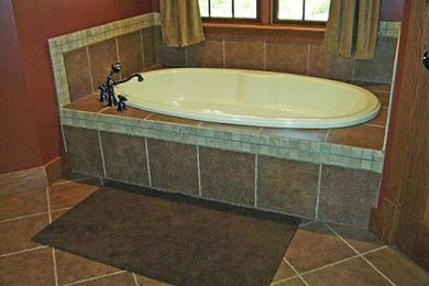 Inspiration for a mid-sized beige tile bathroom remodel in Chicago with orange walls