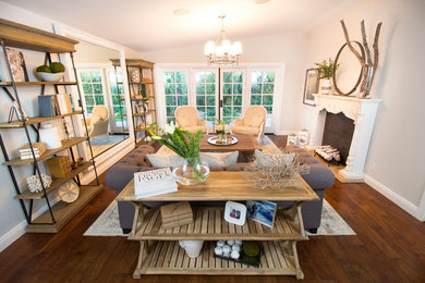 Transitional medium tone wood floor living room photo in Other with gray walls, a standard fireplace and a wood fireplace surround