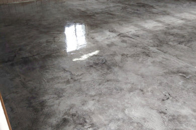 Inspiration for a mid-sized walk-out concrete floor and gray floor basement remodel in Other