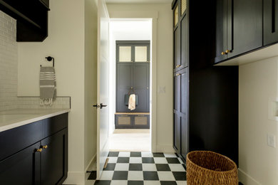 Immagine di una lavanderia eclettica con ante in stile shaker, ante nere, top in quarzo composito, pareti bianche, pavimento multicolore e top bianco