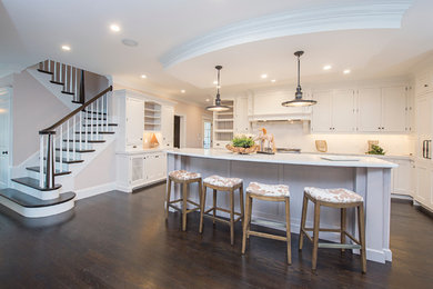 Open concept kitchen - large transitional l-shaped dark wood floor open concept kitchen idea in Boston with beaded inset cabinets, white cabinets, white backsplash, stainless steel appliances and an island