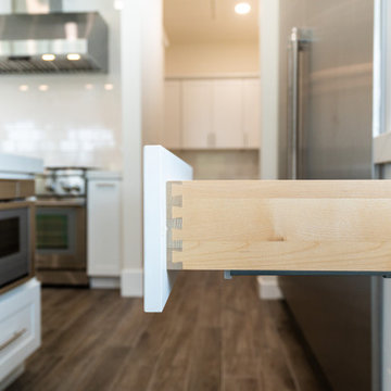Modern White Shaker Kitchen with Oversized Island & Custom Storage Solutions