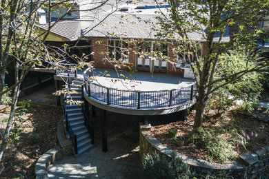 This is an example of a large traditional backyard deck in Atlanta with no cover.