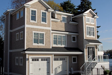 Photo of a mid-sized contemporary three-storey exterior in Boston with wood siding and a gable roof.