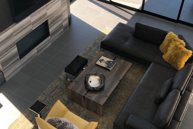Inspiration for a mid-sized transitional open concept porcelain tile and gray floor family room remodel in Las Vegas with gray walls, a ribbon fireplace, a stone fireplace and a tv stand