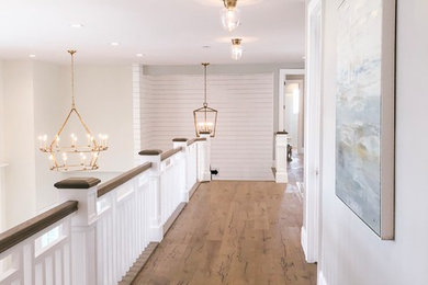 Inspiration for a 1960s medium tone wood floor hallway remodel in Salt Lake City with gray walls