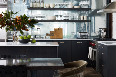 Urban l-shaped medium tone wood floor open concept kitchen photo in New York with metallic backsplash, an island, an undermount sink, flat-panel cabinets, blue cabinets, marble countertops, glass sheet backsplash and stainless steel appliances