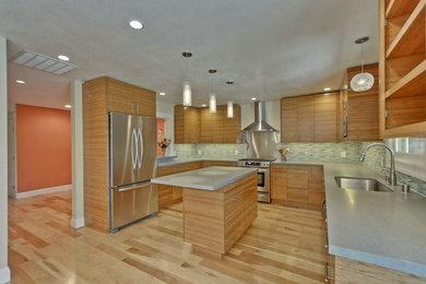 Large trendy u-shaped light wood floor open concept kitchen photo in San Francisco with medium tone wood cabinets, quartz countertops, green backsplash, stainless steel appliances, an undermount sink, flat-panel cabinets, matchstick tile backsplash and an island