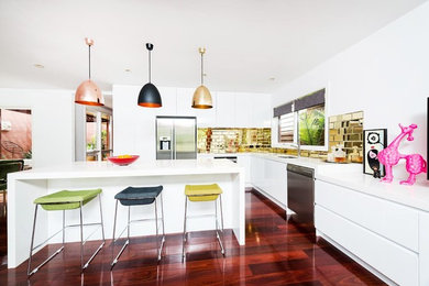 Kitchen in Melbourne with an undermount sink, quartz benchtops, mirror splashback, stainless steel appliances, dark hardwood floors and with island.