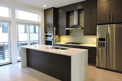 Inspiration for a modern light wood floor eat-in kitchen remodel in Philadelphia with a single-bowl sink, flat-panel cabinets, dark wood cabinets, quartzite countertops, multicolored backsplash, porcelain backsplash, stainless steel appliances, an island and white countertops