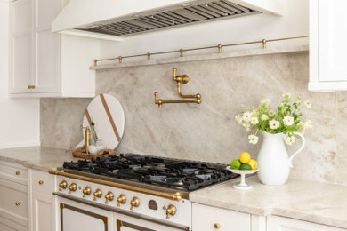 Large transitional kitchen photo in Atlanta with a farmhouse sink, white cabinets and an island