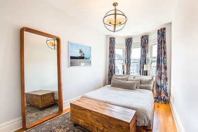 Bedroom - transitional guest medium tone wood floor and yellow floor bedroom idea in San Francisco with white walls