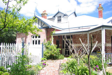 This is an example of a mid-sized traditional home design in Perth.