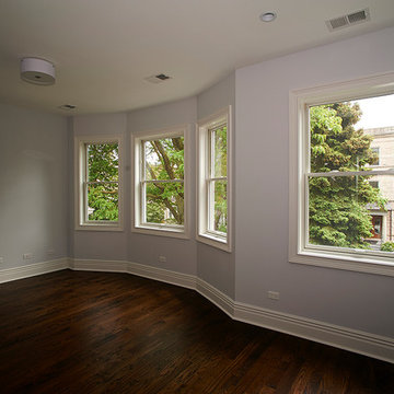 Light-Filled Bay Window Bedroom with Polished Hardwood Floors