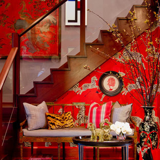 This is an example of an eclectic entryway in New York with red walls.