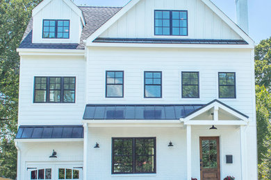 Example of a mid-sized country white three-story concrete fiberboard exterior home design in DC Metro with a mixed material roof
