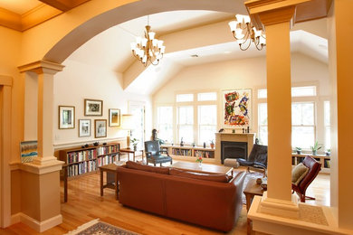 Living room library - large contemporary open concept medium tone wood floor living room library idea in Boston with white walls, a standard fireplace and no tv