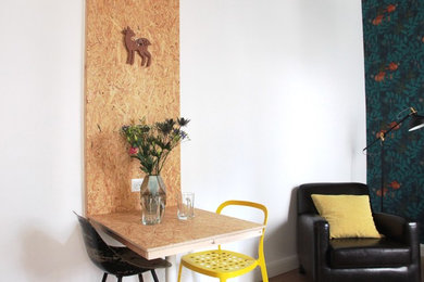 This is an example of a small contemporary dining room in Strasbourg with white walls and no fireplace.