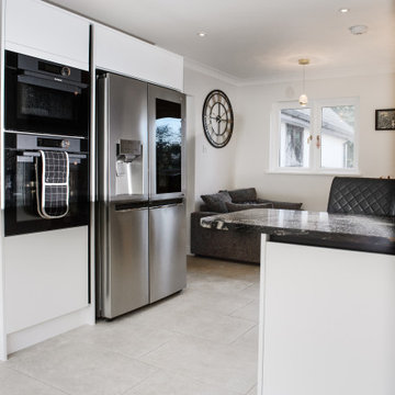 The kitchen features a built in oven and custom fitted unit for the larder fridg