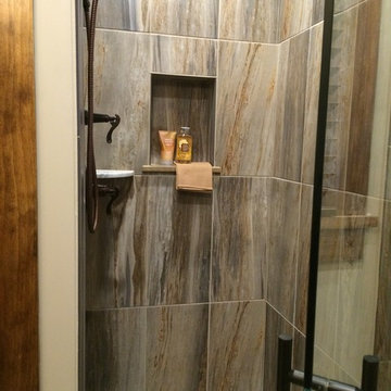 River rock mosaic tile inlay bath floor leads to shower