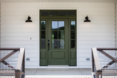 This is an example of a farmhouse porch design in Raleigh.
