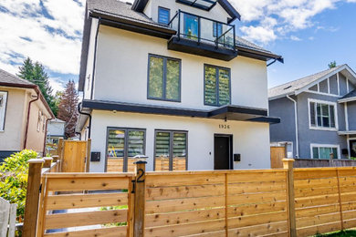 Inspiration for a mid-sized contemporary white three-story stucco duplex exterior remodel in Vancouver with a hip roof, a shingle roof and a black roof