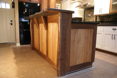 Example of a small arts and crafts single-wall porcelain tile open concept kitchen design in Seattle with an undermount sink, shaker cabinets, light wood cabinets, granite countertops, multicolored backsplash, stone tile backsplash, stainless steel appliances and an island