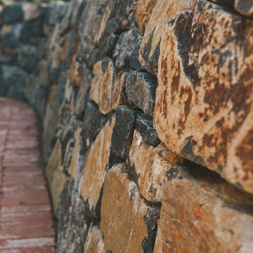 Stacked Stone Retaining Wall + Brick Pathway